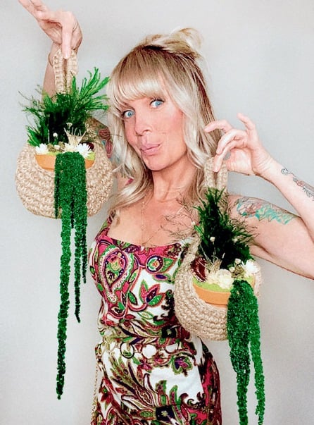 Danielle Smith poses with her adorable mossy hanging planters 
